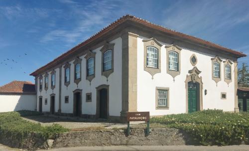 a white building with a sign in front of it at Casa De Fatauncos in Vouzela