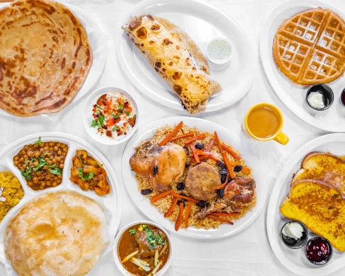 a white table with plates of food on it at Hotel Astro in Gilgit