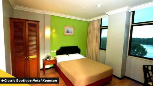 A bed or beds in a room at Classic Boutique Hotel Kuantan