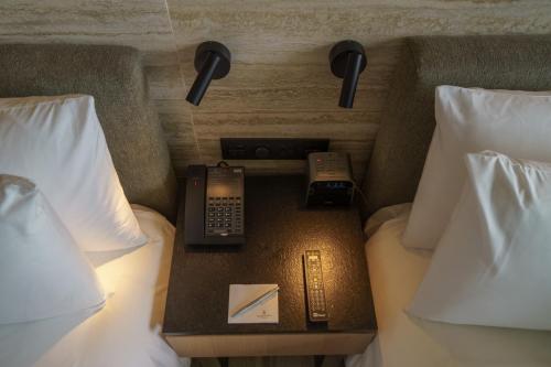 ein Hotelzimmer mit 2 Betten, einem Telefon und einem Nachttisch in der Unterkunft Renaissance Cancun Resort & Marina in Cancún