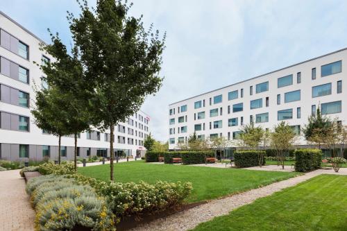 an apartment building with a park in front of it at Moxy Munich Ostbahnhof in Munich