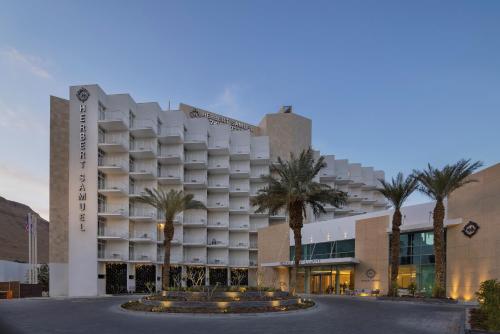 um hotel com palmeiras em frente a um edifício em Herbert Samuel Hod Dead Sea Hotel em Ein Bokek