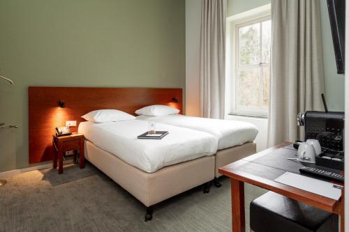 Cama ou camas em um quarto em Leerhotel Het Klooster