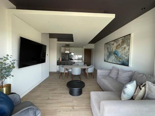 a living room with a couch and a table at Apartamento en Lobby33 in Guadalajara