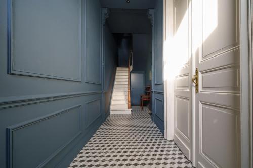 a hallway with a door and a tile floor at à la pointe de l'ile in Namur