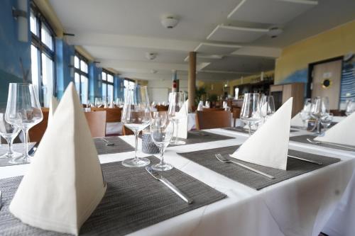 a table with wine glasses and napkins on it at StroamCamp Schwedt - a84456 in Schwedt