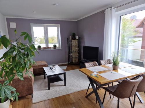 a living room with a table and a couch at Moderne Penthouse Wohnung in Schleswig