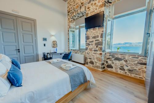 A bed or beds in a room at Impero Nafplio Hotel & Suites