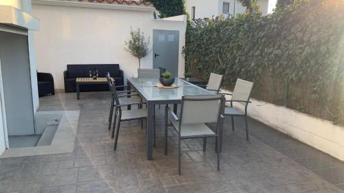 a table and chairs sitting on a patio at Rodhes Playa B-1 in Roses