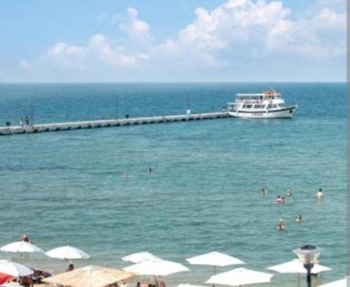 a cruise ship in the ocean with people in the water at Dellmar Apartment in Perea