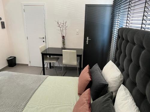 a bedroom with a bed and a desk and a table at Escape in Leuven - self check in in Leuven