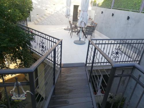 a stairway leading to a patio with tables and chairs at Bika in Omiš