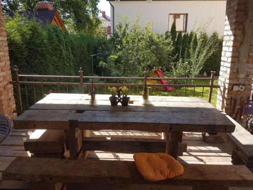 a wooden picnic table with plants on it in a yard at Rest house in Truskavets