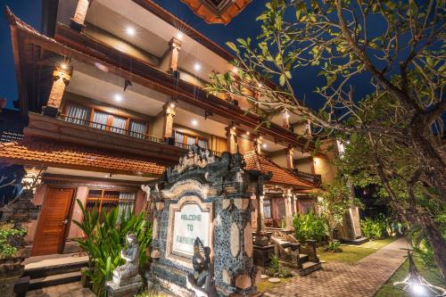 a building with a sign in front of it at Suka Beach Inn in Kuta