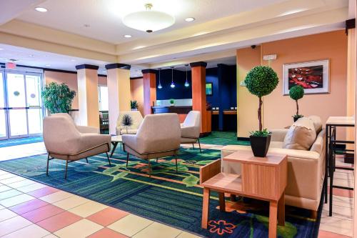 a lobby of a hotel with chairs and tables at Fairfield Inn and Suites by Marriott Indianapolis/ Noblesville in Noblesville