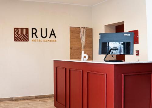 a red counter in a room with a sign on the wall at Rua Hoteles Talara in Talara