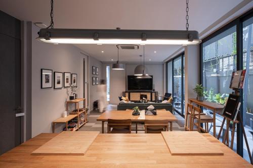 a living room with tables and a couch at humble abode - vacation home in Bangkok