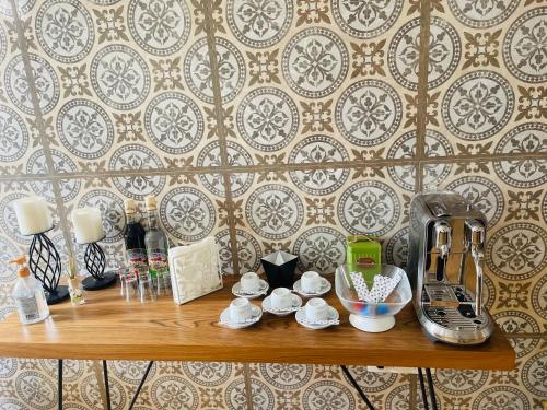 una mesa de madera con una cafetera en la pared en KAZARÃO DI MAVETE - Guesthouse, en Praia