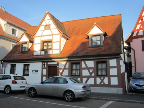 um carro branco estacionado em frente a uma casa em Gästehaus Engelgasse Herzogenaurach em Herzogenaurach