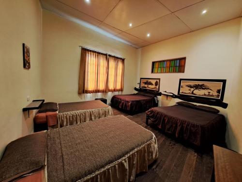 A bed or beds in a room at Hostal Huacachina Sunset