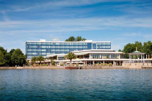 a large blue building next to a body of water at Courtyard by Marriott Hannover Maschsee in Hannover