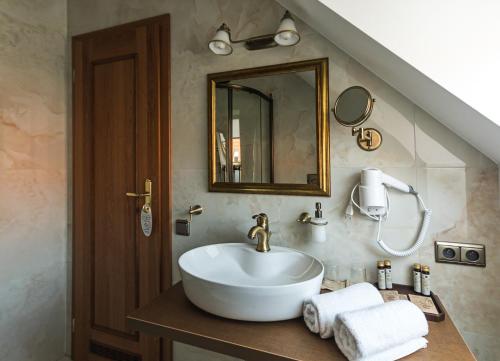 a bathroom with a sink and a mirror at Hotel Octarna - Free parking in Kroměříž