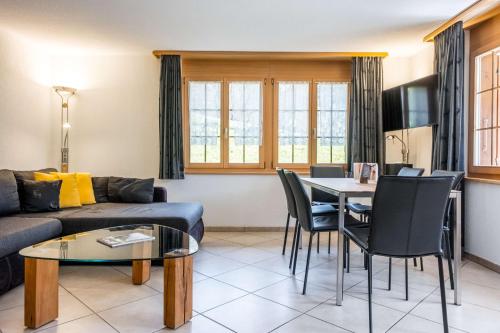 a living room with a couch and a table at Apartment Dolce Vita - GRIWA RENT AG in Grindelwald