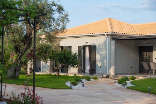 a white house with an orange roof at Aerinos private villa in Lefkada Town