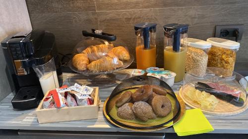 a table with a bunch of pastries and bread on it at B&B Feni in Pompei