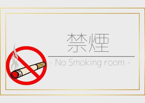 Una señal que dice que no se puede fumar en la habitación con un cigarrillo. en Tennen Onsen Kakenagashi no Yado Hotel Pony Onsen - Vacation STAY 50911v, en Towada