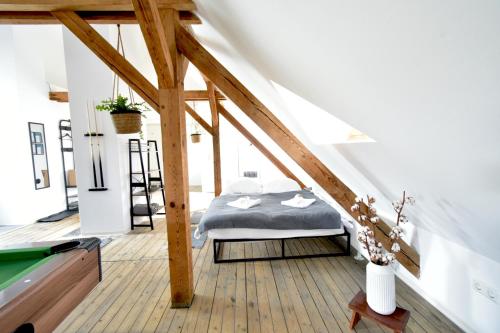 a bedroom with a bed and a pool table at Black Billard l Loft für 2-4 Personen l Wohlfühlen in Altstadtnähe in Landshut