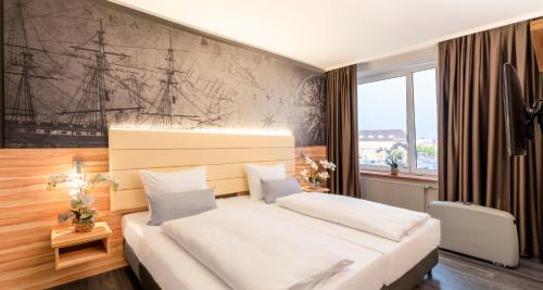 a bedroom with a large white bed and a large window at PLAZA Premium Columbus Bremen in Bremen