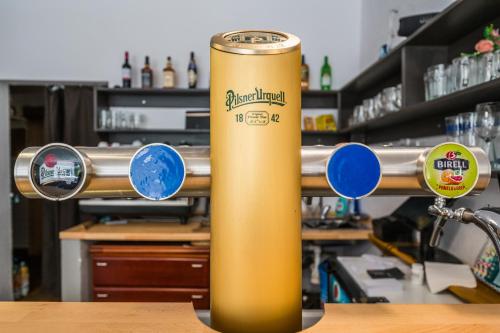 a gold can sitting on a table in a bar at Chata Čeňkovka in Srní