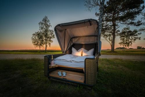 a bed with a canopy in a field at Marina Martinshafen - Beach life in Sassnitz