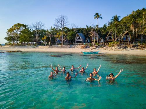 a group of people swimming in the water at Isla - The Island Experience in El Nido