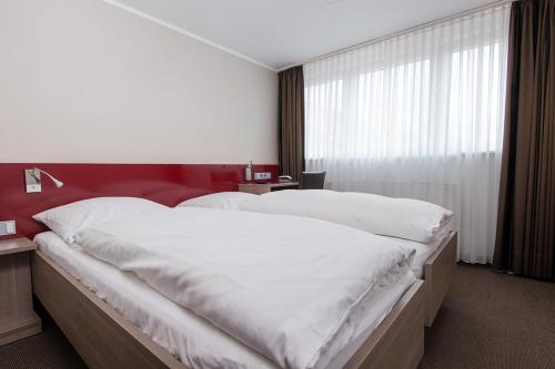 Postel nebo postele na pokoji v ubytování Hotel Rennschuh