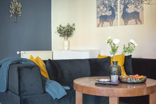 ein Wohnzimmer mit einem Sofa und einem Tisch in der Unterkunft Residenz unter den Linden Specht in Mühlhausen