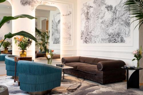 a living room with a couch and a table at Sapphire House Antwerp, Autograph Collection in Antwerp