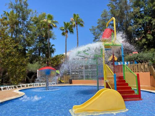 a pool with a water park with a water slide at Aparthotel SunClub Salou in Salou