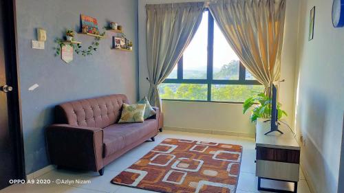 a living room with a couch and a large window at TOP Muzaffar Homestay in Ayer Keroh