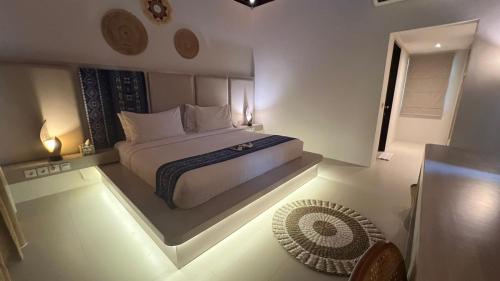 a bedroom with a large bed with lights on the floor at Living Asia Resort and Spa in Senggigi 