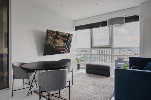 a living room with a table and chairs at Platinum Towers J&K in Warsaw