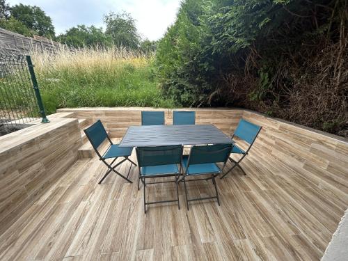 a table and chairs on a wooden deck at Résidence 3 etoiles Les thèmes Proche Lux, Metz, Cattenom in Hayange