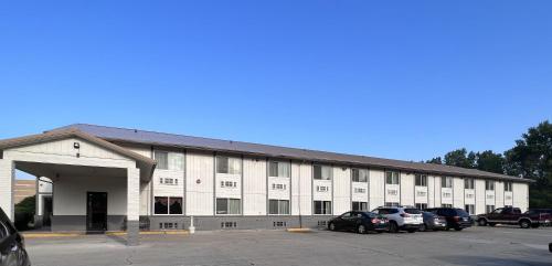 a large white building with cars parked in a parking lot at FairBridge Inn Express Chesterton in Chesterton