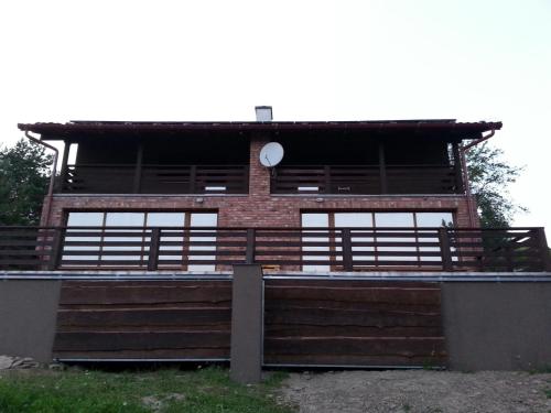 a building with windows and a clock on it at Chata pri Vode in Kelča