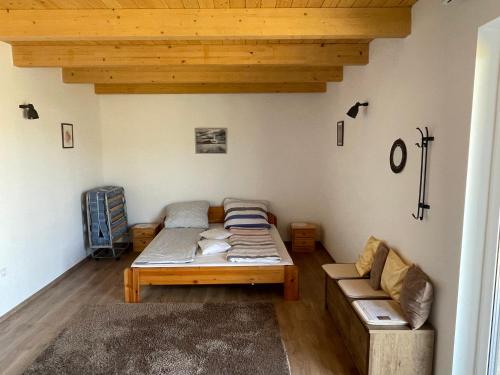 a living room with a bed and a couch at Győri vendégház in Demjén