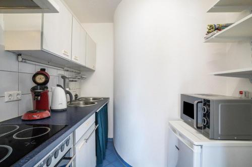 a small kitchen with a microwave and a counter at Ferienwohnung Schläfer in Kappel-Grafenhausen