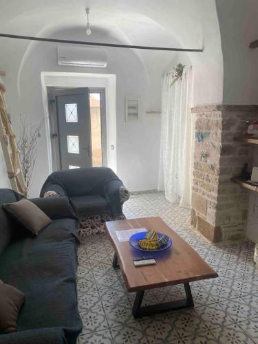 a living room with a couch and a coffee table at Cozy stone built apartment in Nénita! in Chios