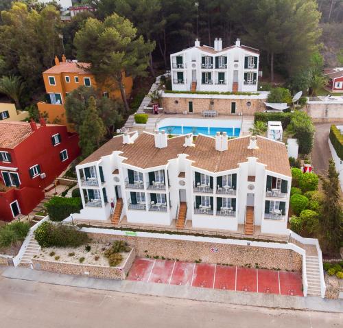 an aerial view of a large white house at The Desmais in Cala Galdana