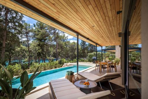 an external view of a house with a swimming pool at Valamar Amicor Resort in Stari Grad